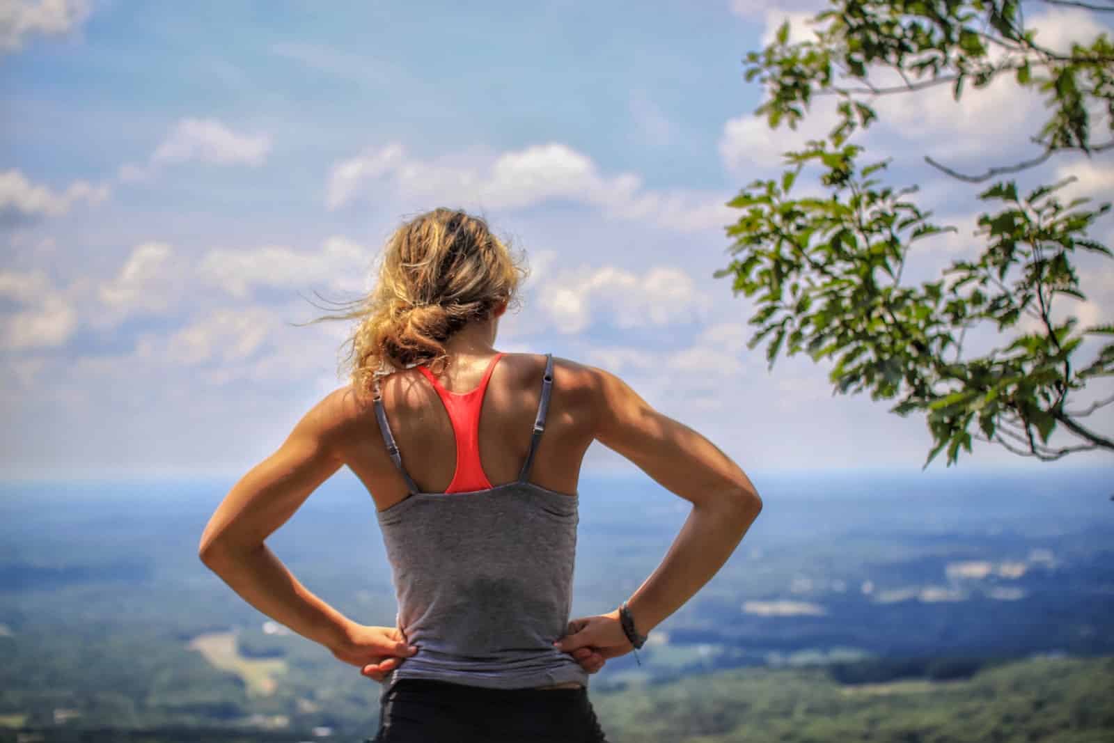 Woman standing near tree looking below-addicted running