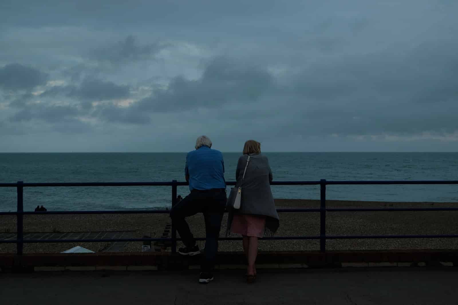 Couple sitting on bench near sea during daytime-breaking up and getting back
