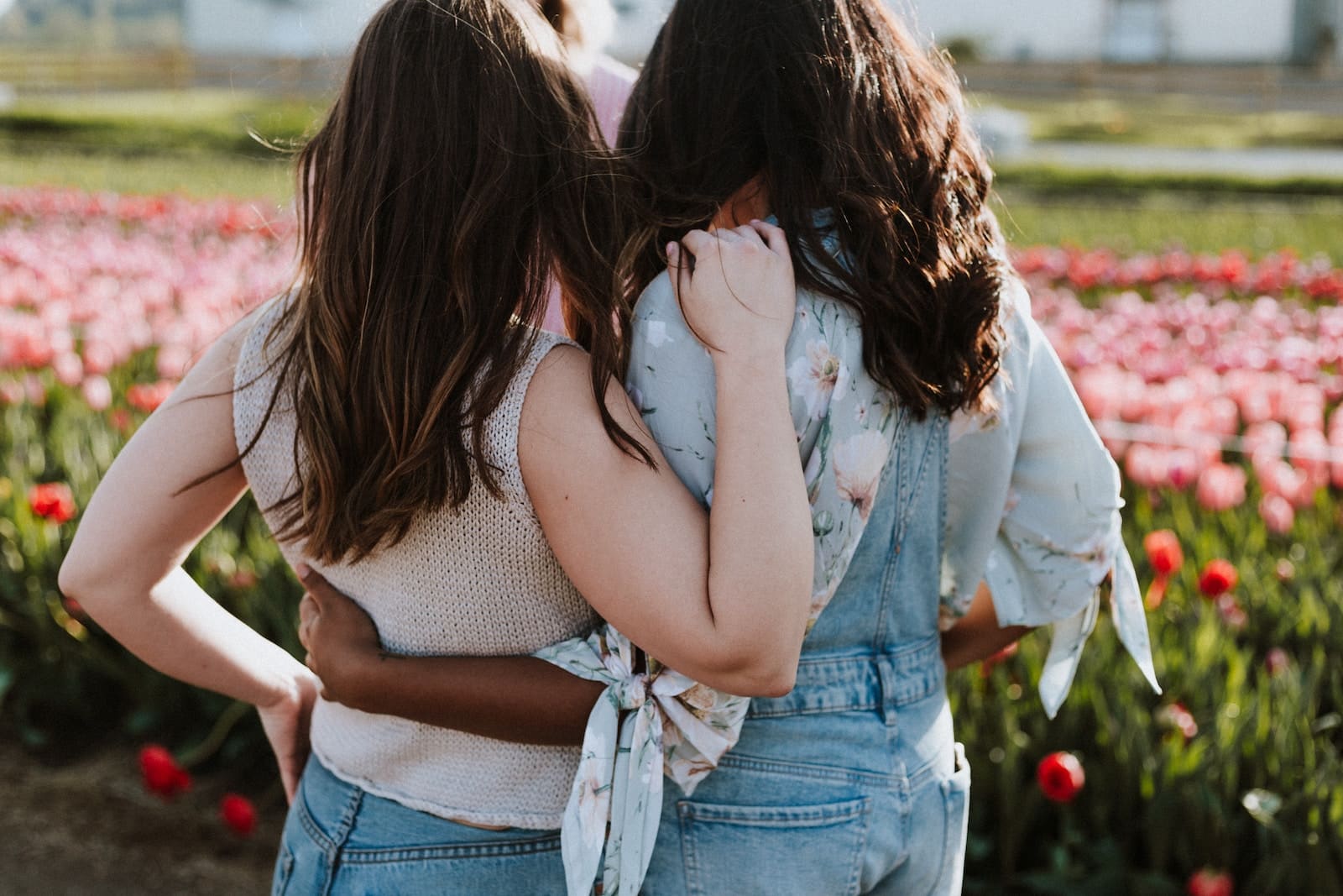 Two women in front of flowers-how to help a friend through a break up