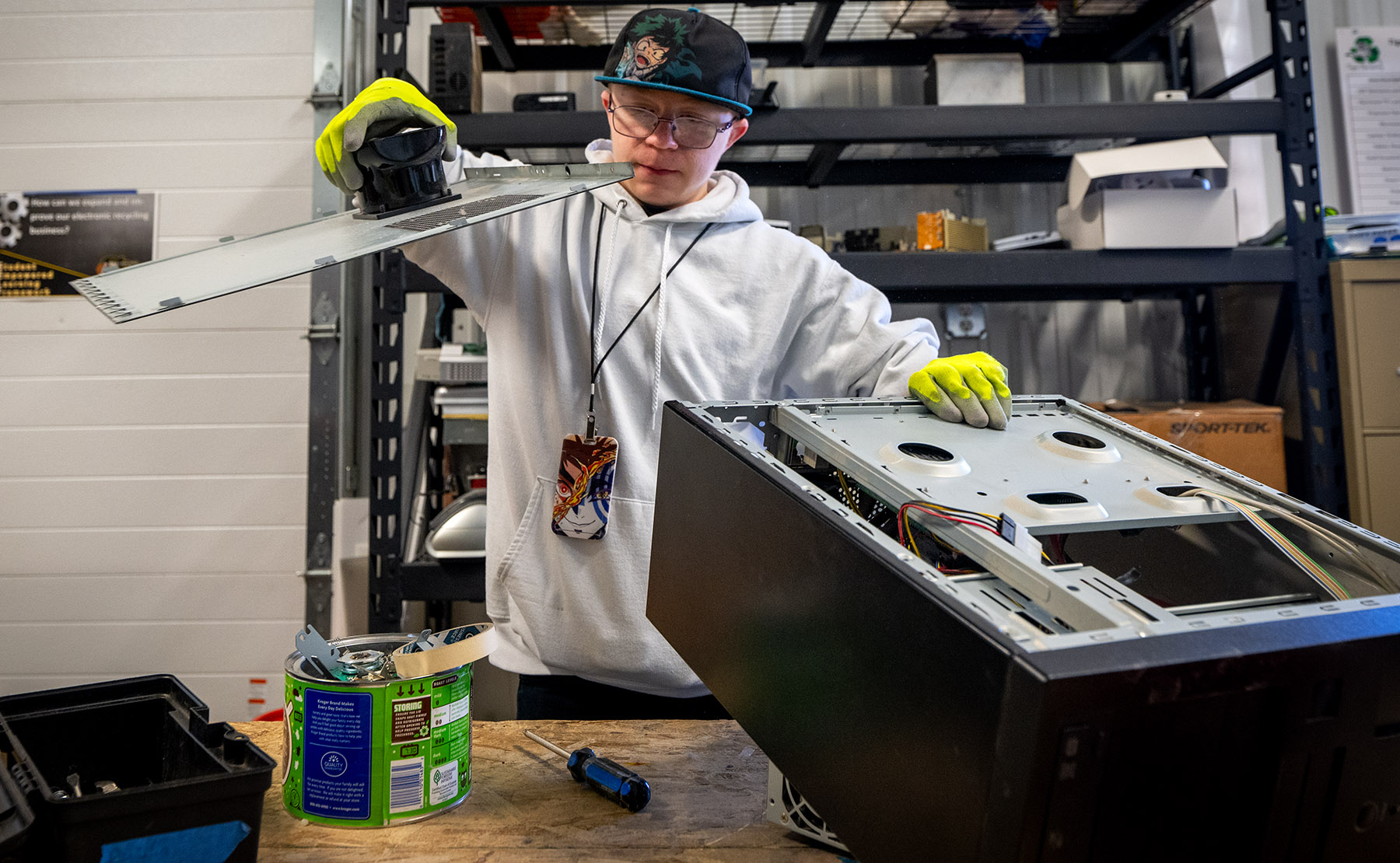 A student takes apart an old desktop computer