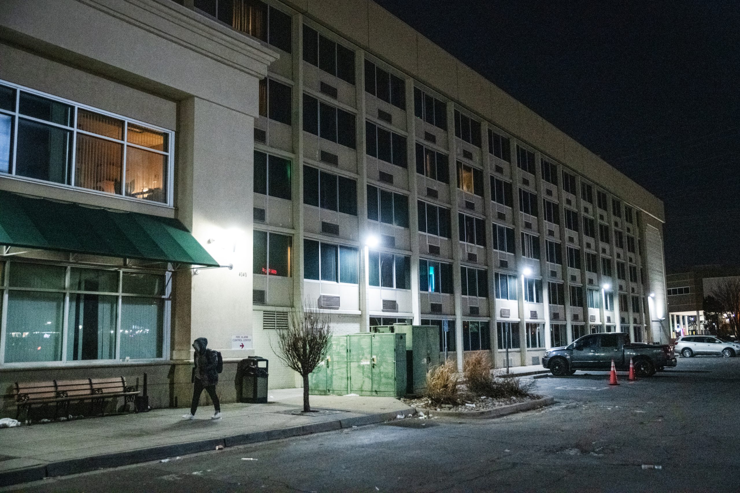 A person walks past a former hotel that nows shelters people transitioning from homelessness