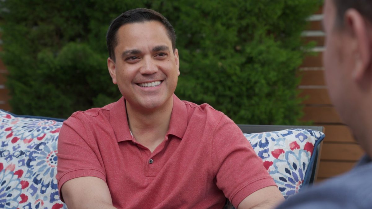 A campaign photo of Sean Camacho sitting on an outdoor couch.