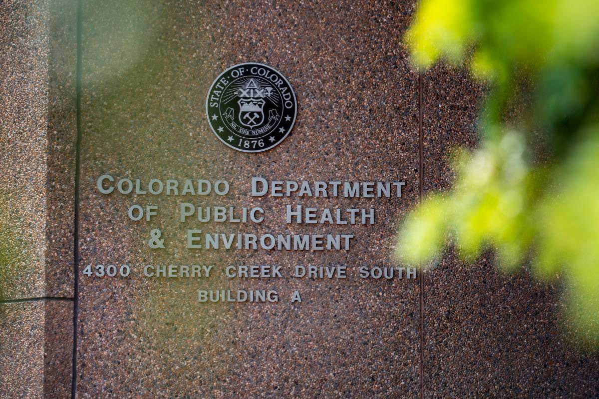 Signage for the Colorado Department of Public Health and Environment, located at 4300 Cherry Creek Drive South, Building A, with the state emblem above the text.