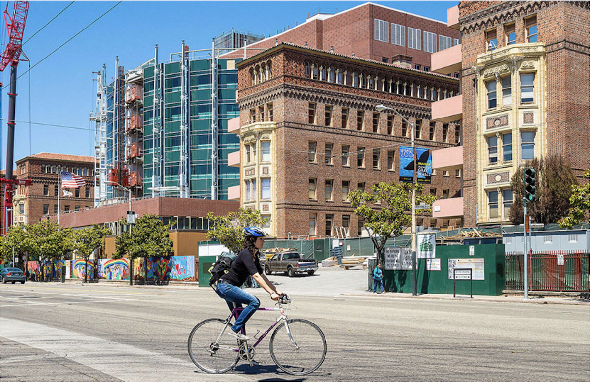 A bicyclist passes Zuckerberg San Francisco General Hospital.