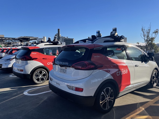 A parking lot full of Cruise automatous cars.