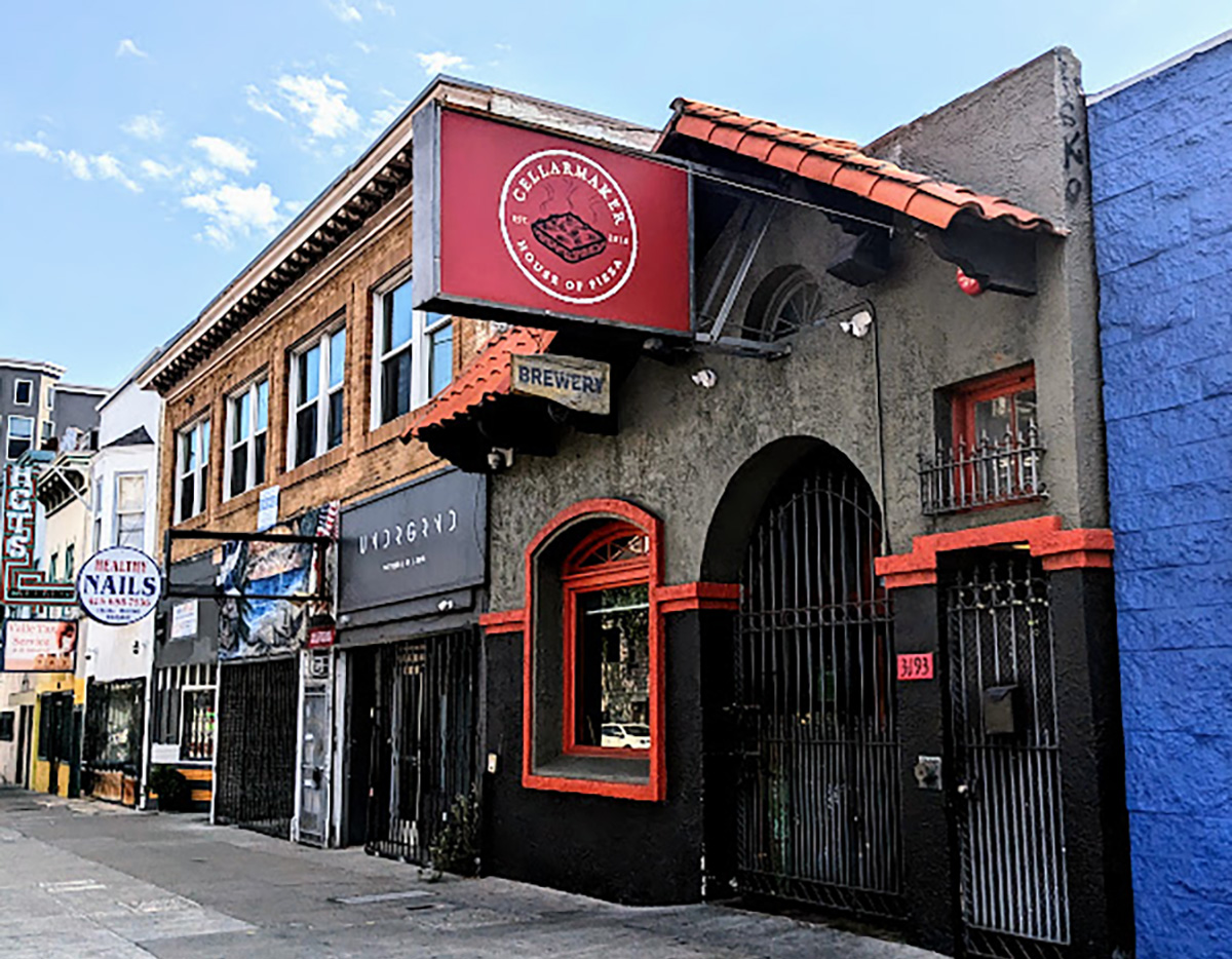 A building with a red and blue sign on the side of it.