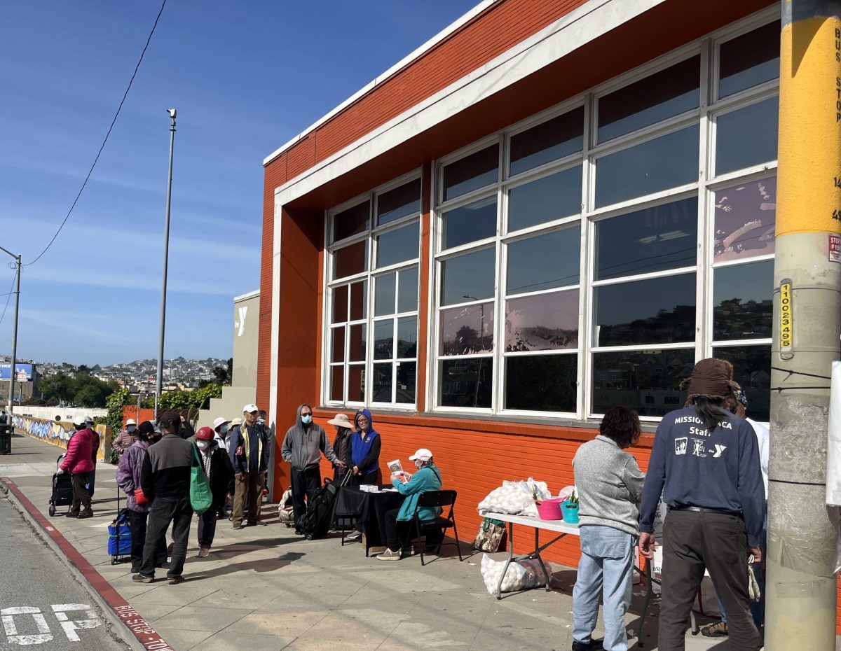 A line of people outside the Food Bank pantry at the Mission YMCA.