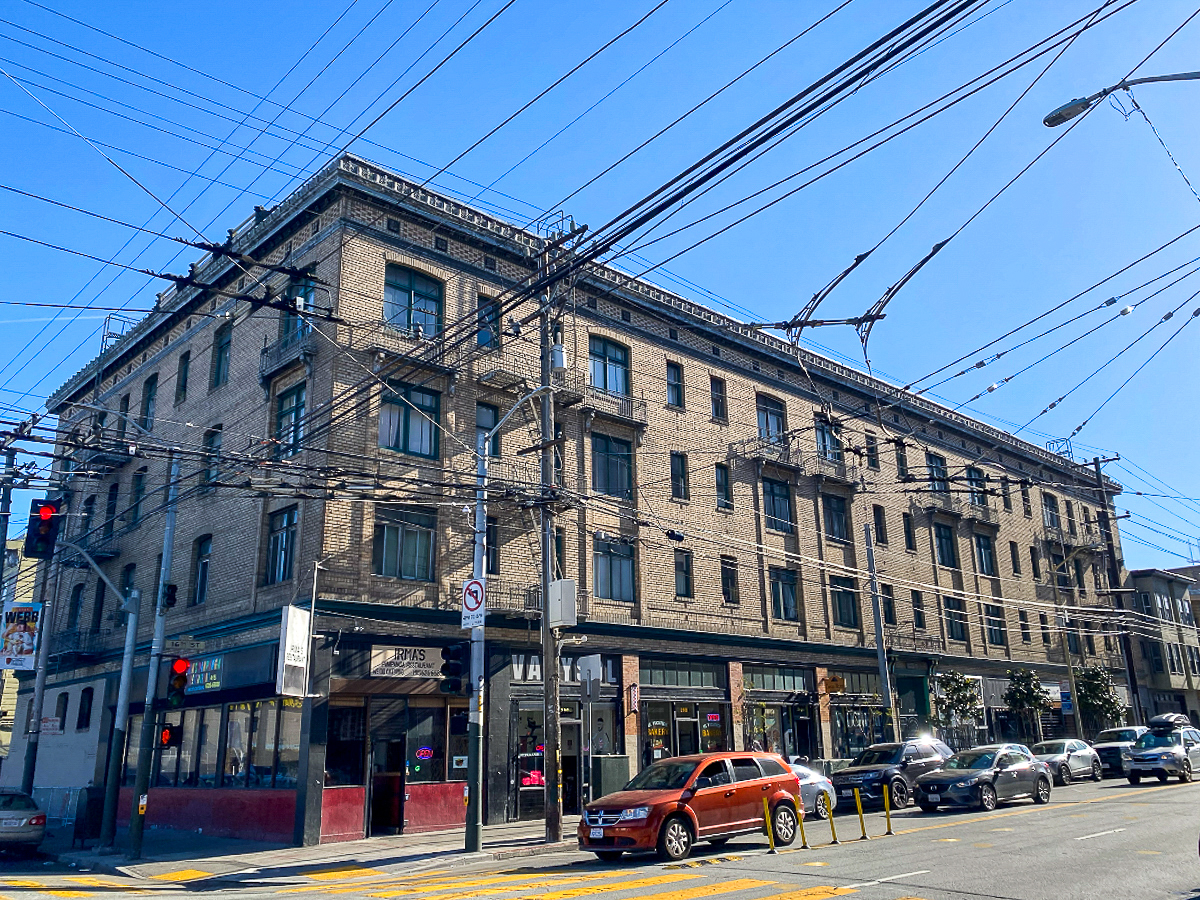 A brick building at the corner of an intersection. It will soon become affordable housing.