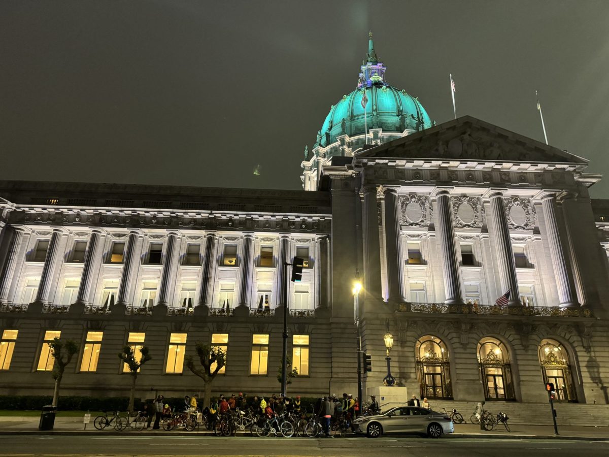 Attendees arrive at City Hall to place a ghost bike in front of it, for the last four years officials have lit up the building white to honor the ride on Wednesday May 15, 2024. Photo by Oscar Palma.