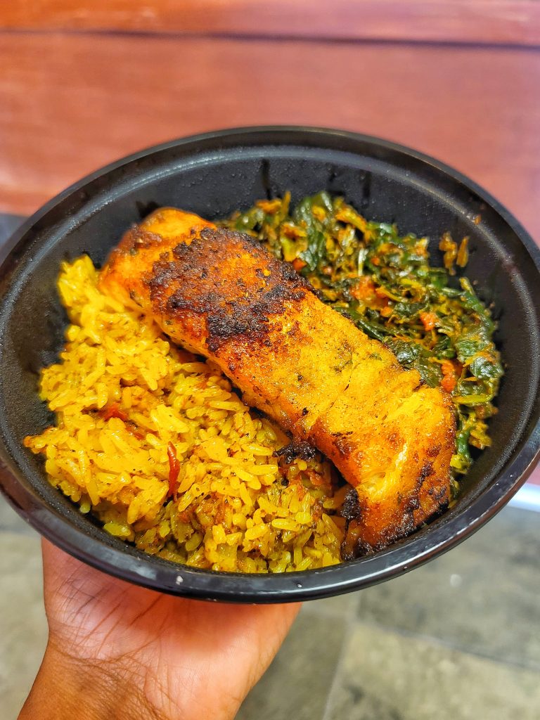 Salmon bowl with jollof rice and spinach stew at Open Crumb in Anacostia