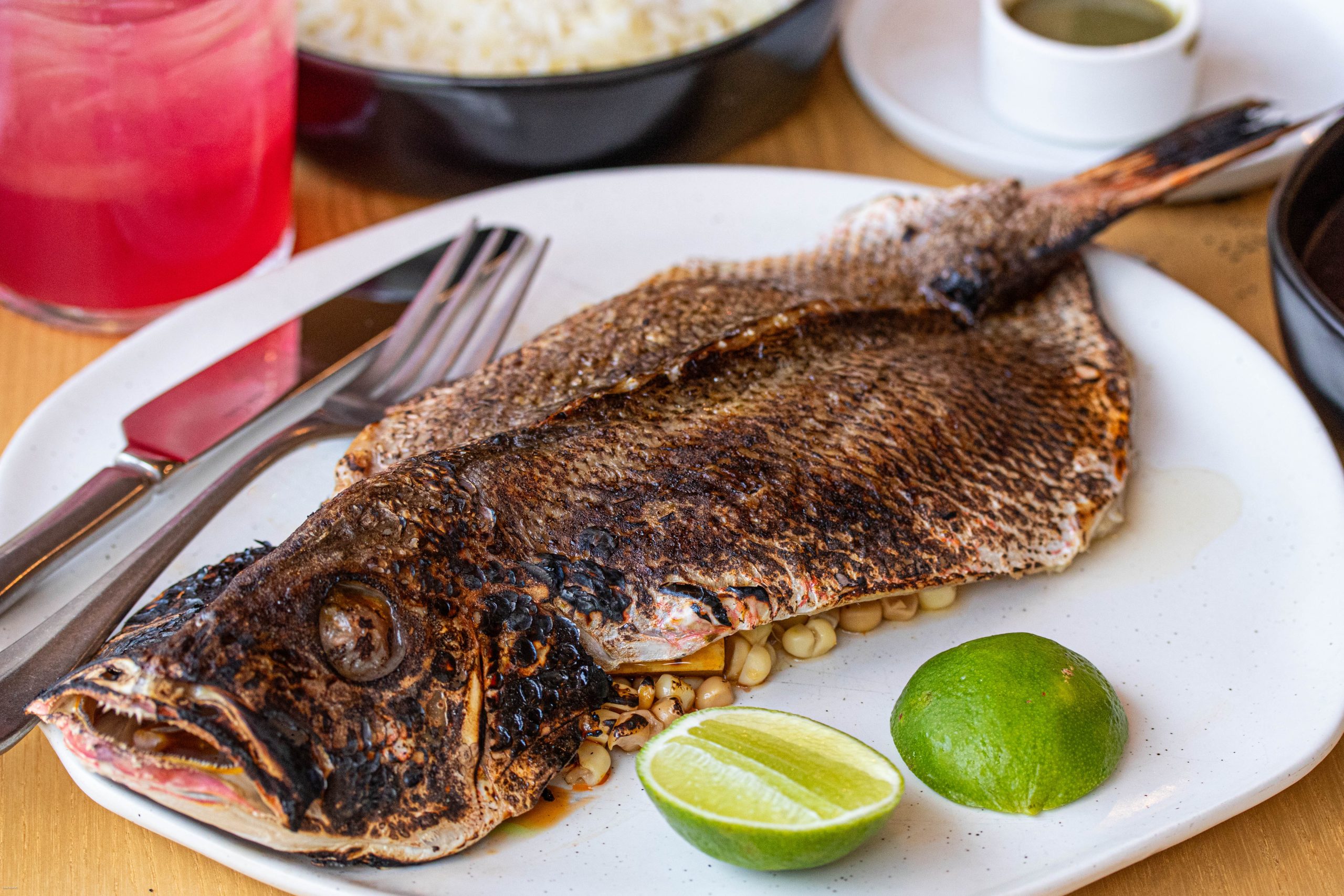 A whole butterflied snapper on a plate.