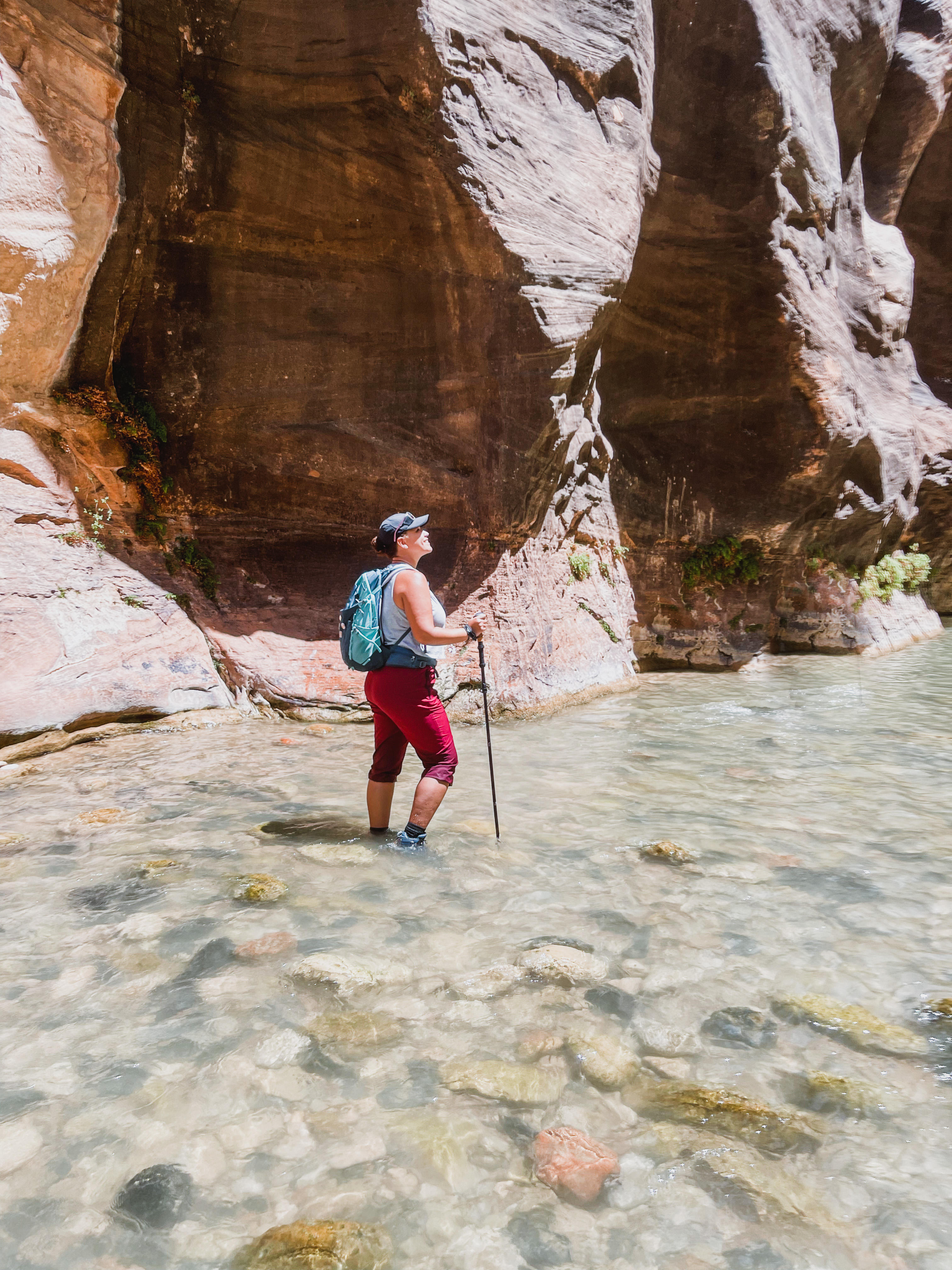 woman hiking the narrows in zion