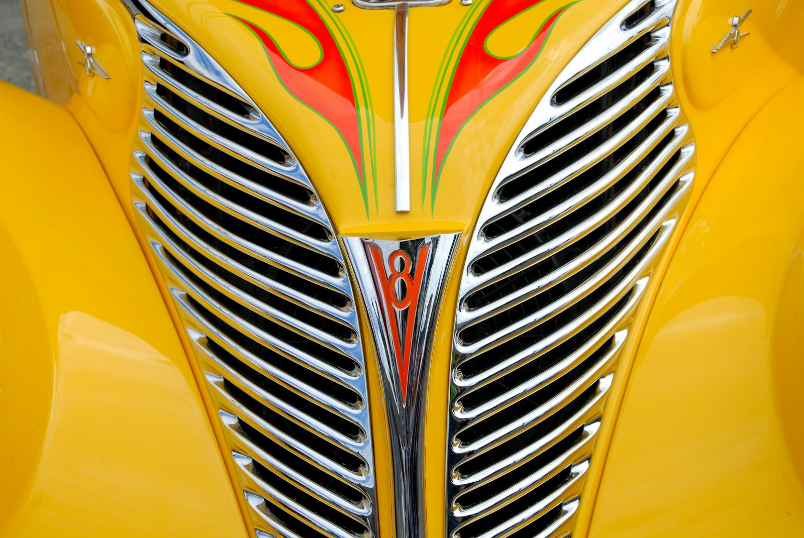 a close up of the front of a yellow car