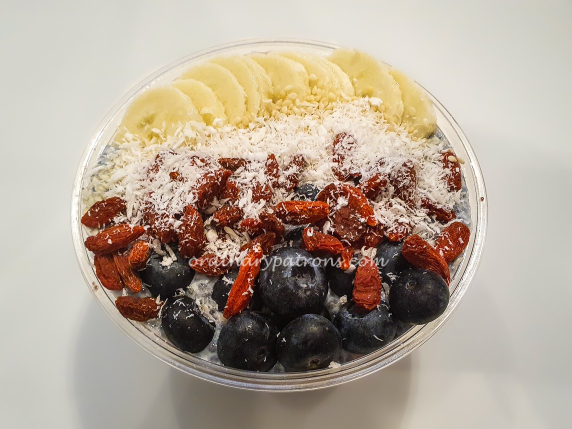 acai and topped with goji berries, blueberries, coconut flakes and banana