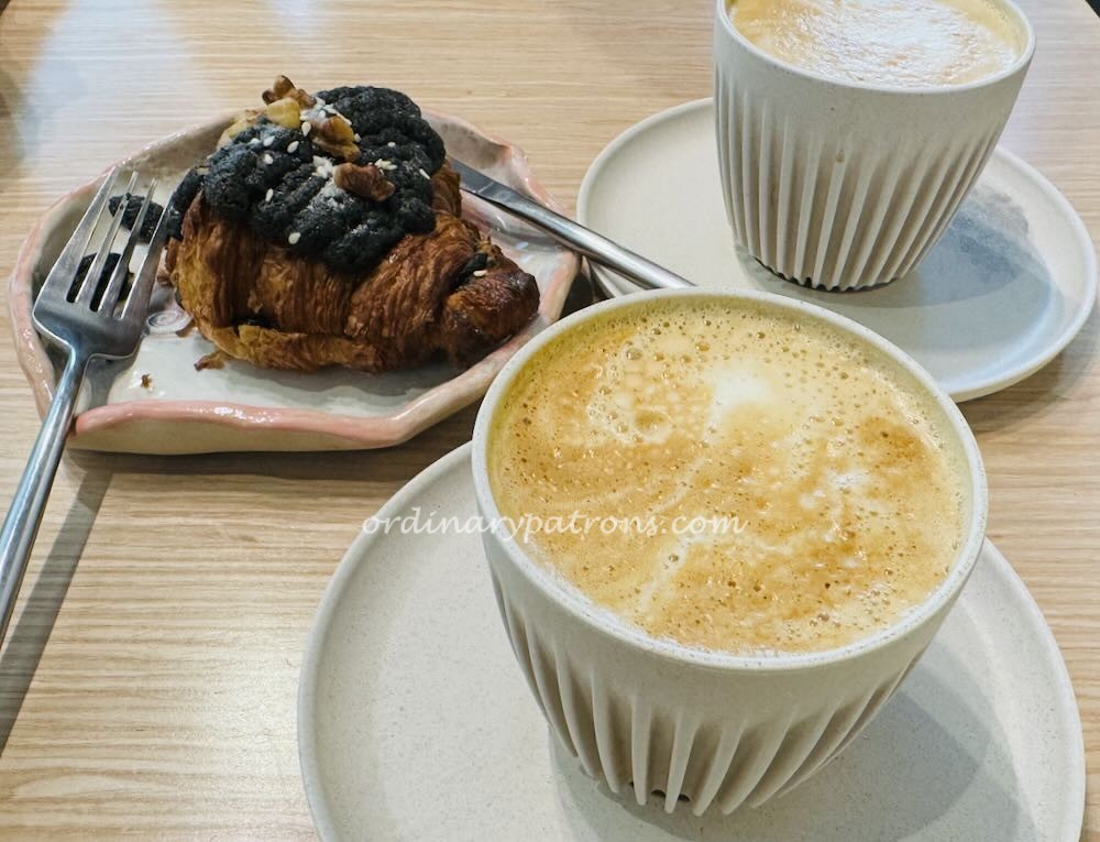 black sesame croissant and cappuccino