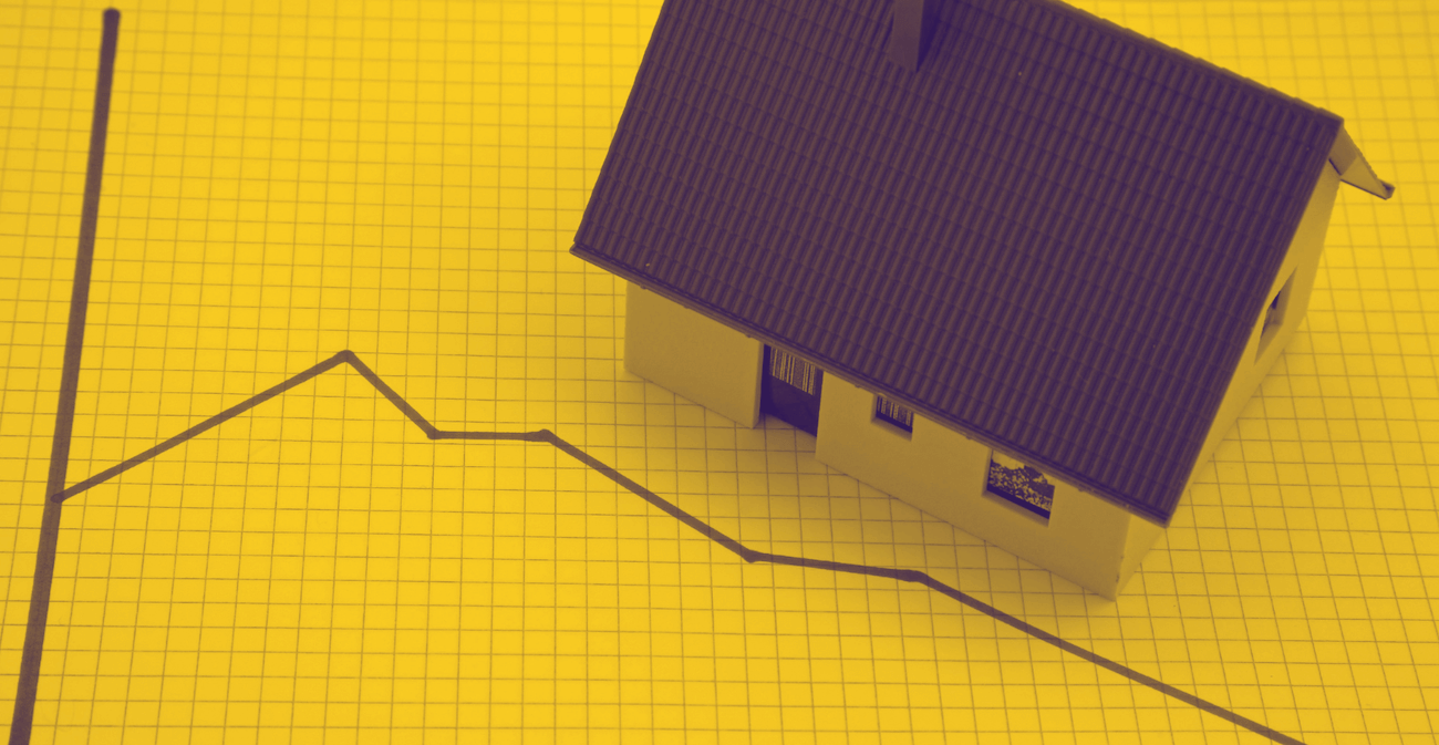 photo illustration showing line graph trending downward and house