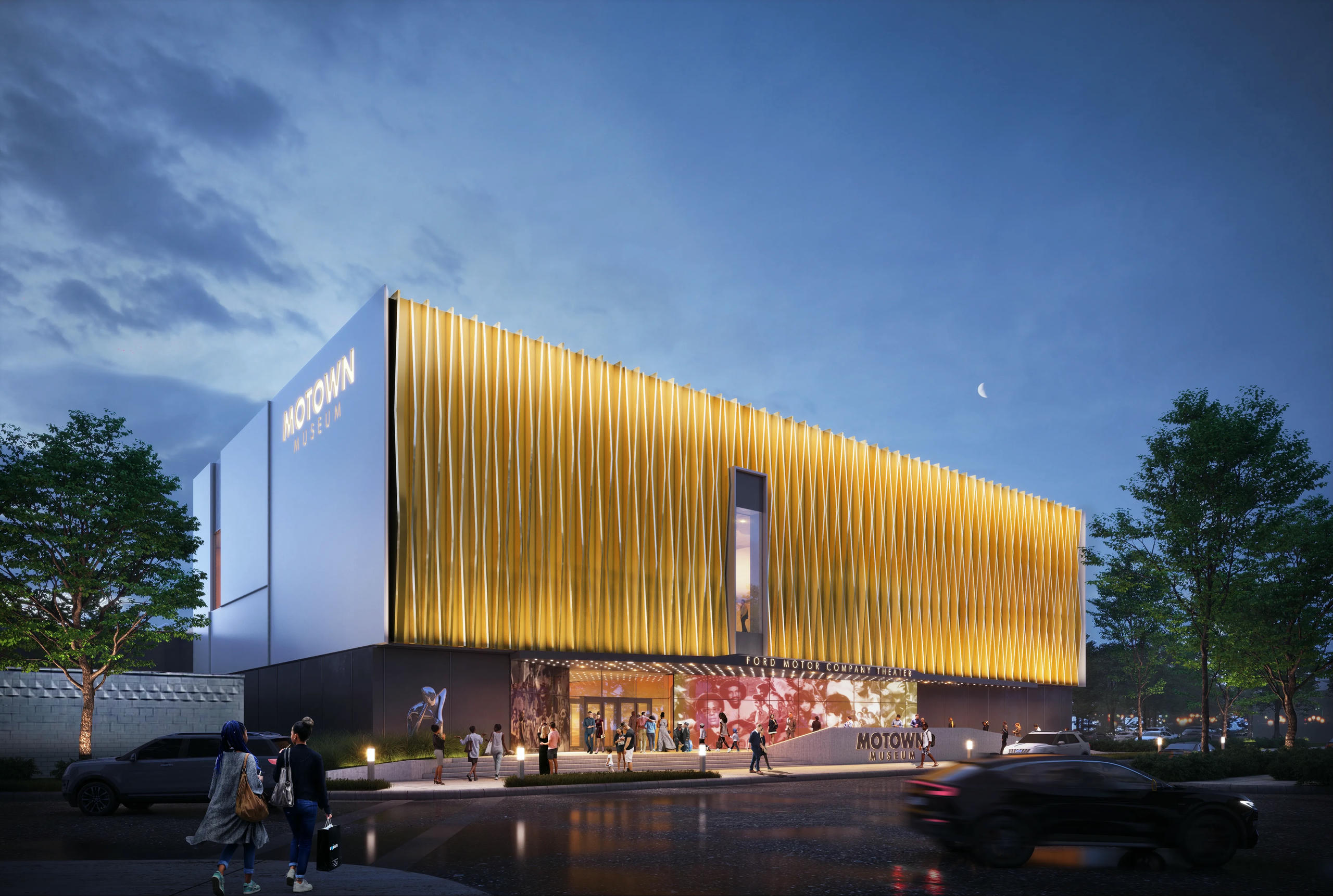 A rendering shows a building lit up at night. It says “Motown Museum” in gold lettering on the top left of the building and in the front. There are people on a sidewalk in between the building and the street.