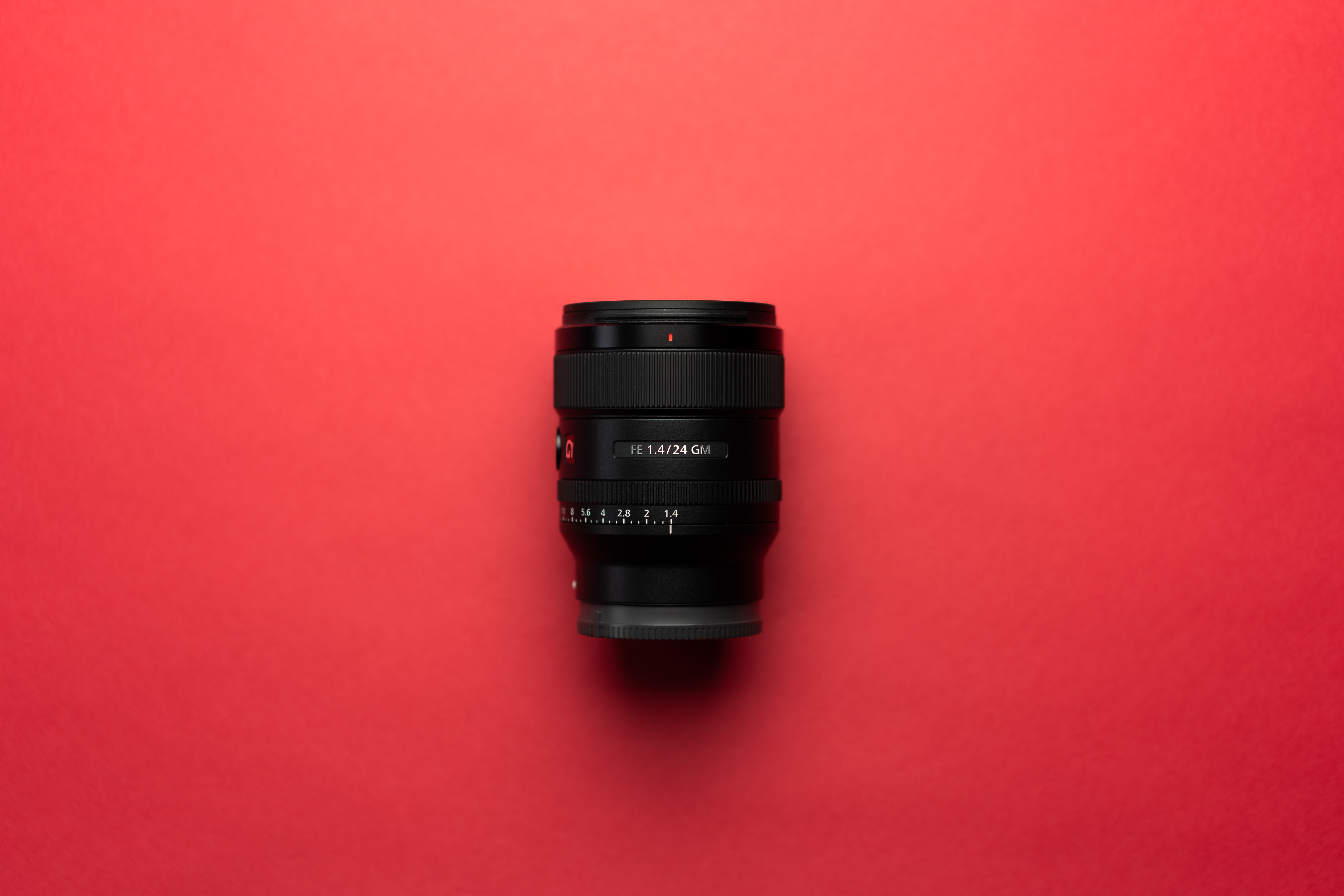 Camera Lens on a Red Background Free Photo