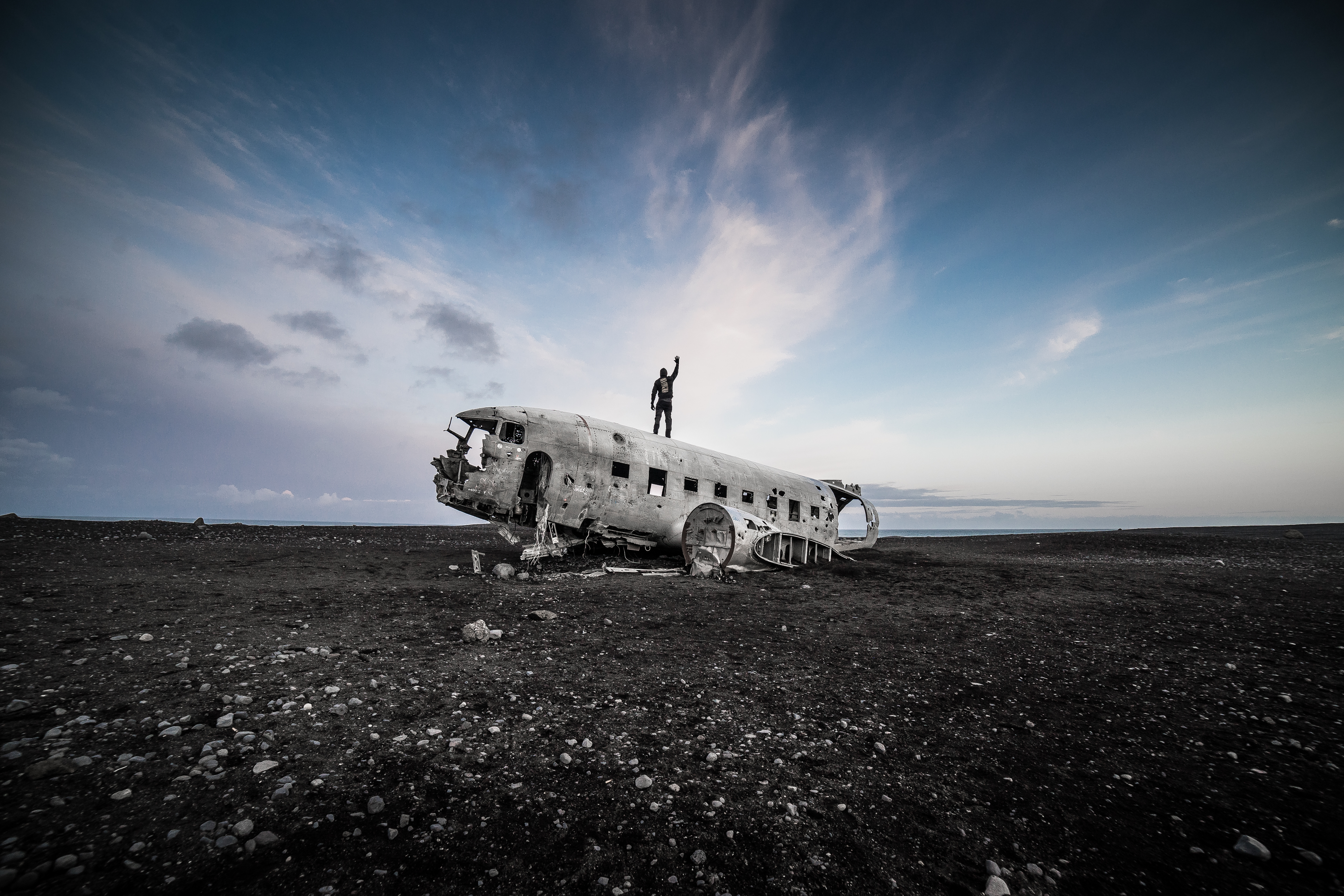 Man Standing on Top of the Iceland Famous Plane Wreckage Free Photo