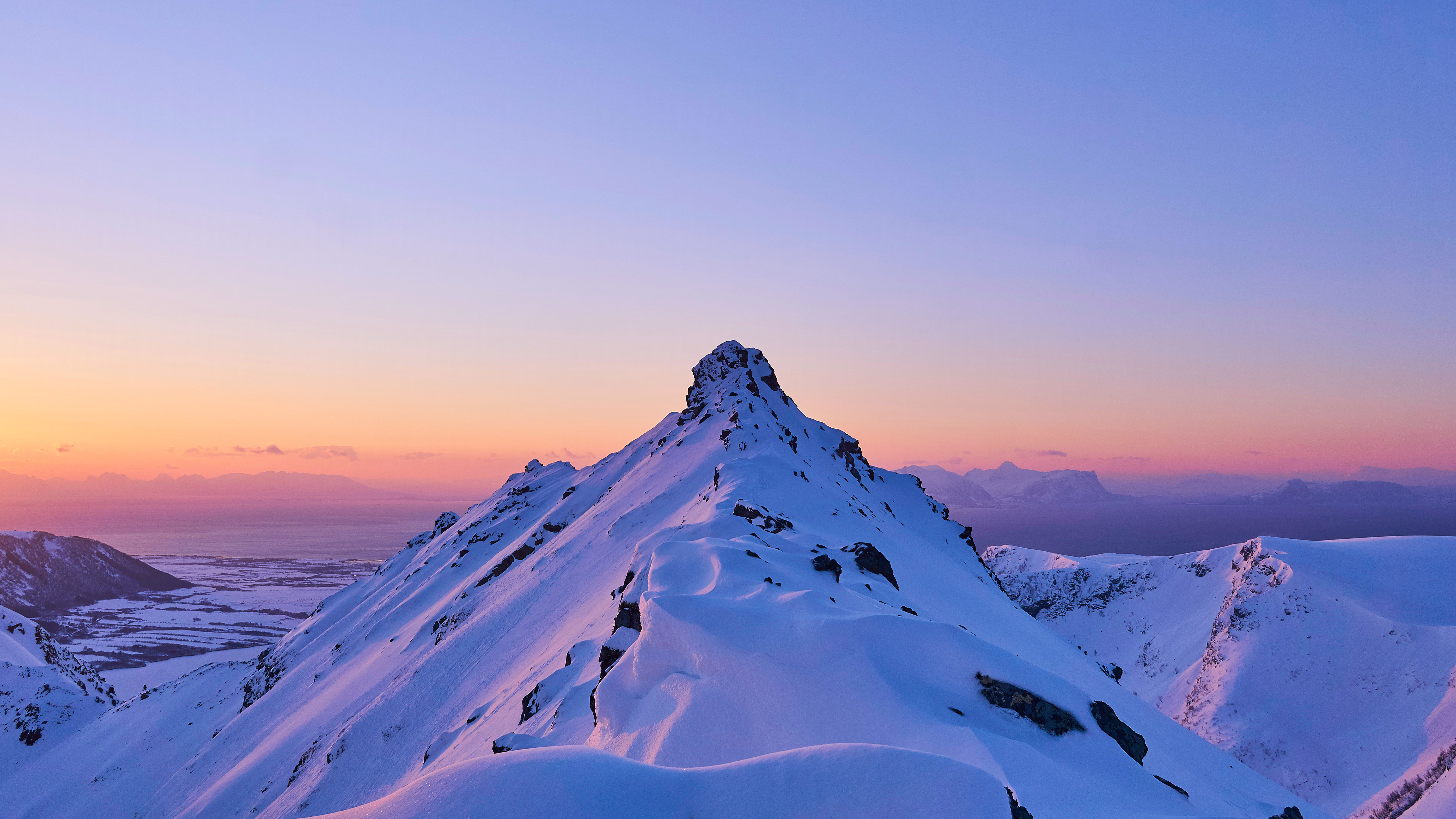 Snowy Mountain Peak with Sunrise Glow Free Photo