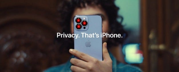 An Apple ‘Privacy. That’s iPhone.’ ad. The three rear-facing camera lenses have been replaced by the staring, red eye of HAL9000 from 2001: A Space Odyssey. Image: Cryteria (modified) https://commons.wikimedia.org/wiki/File:HAL9000.svg CC BY 3.0 https://creativecommons.org/licenses/by/3.0/deed.en