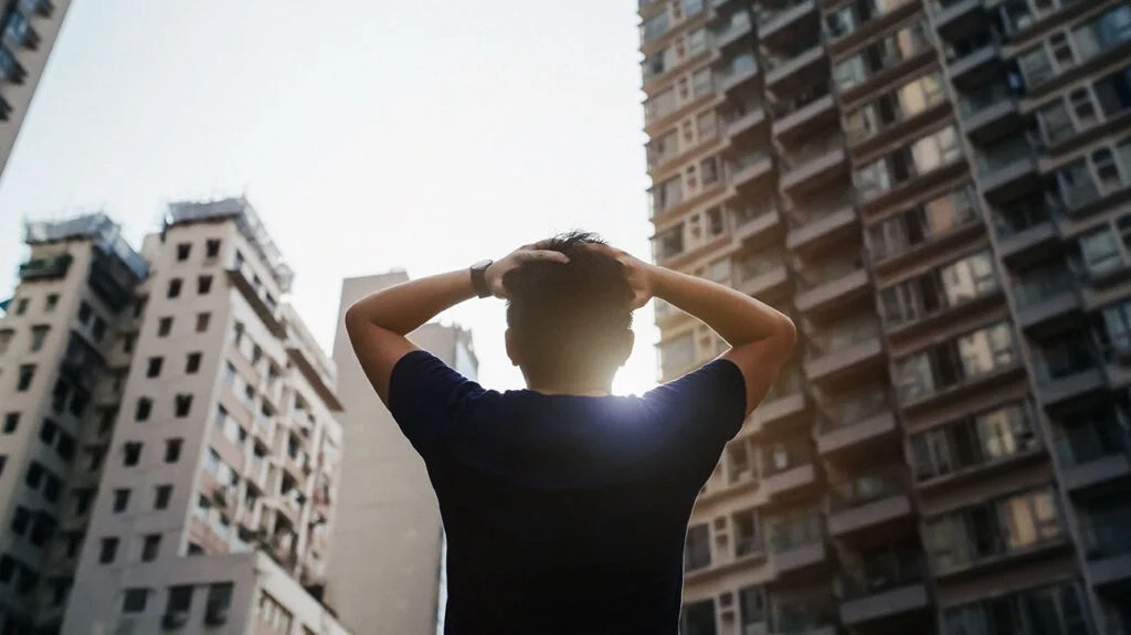 A man with his hands on his head.