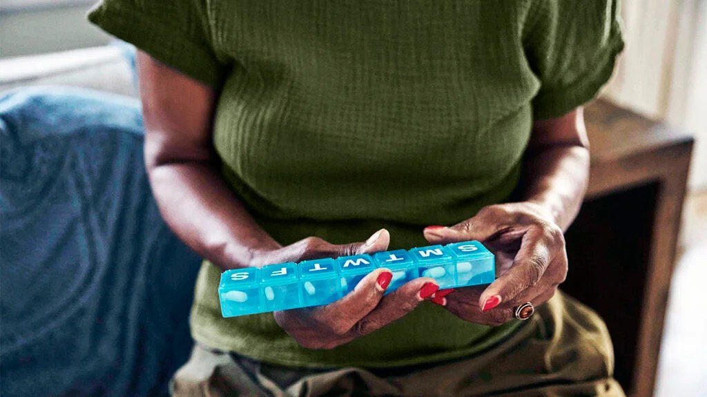 A person holding a pill organizer so they do not miss a dose of antibiotics -2.