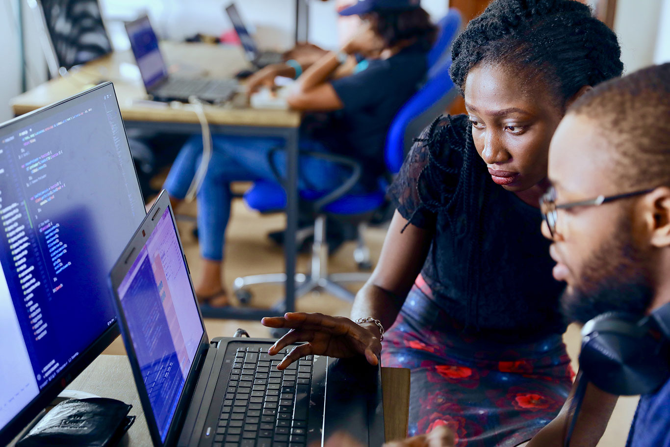 A mentor reviews a students code