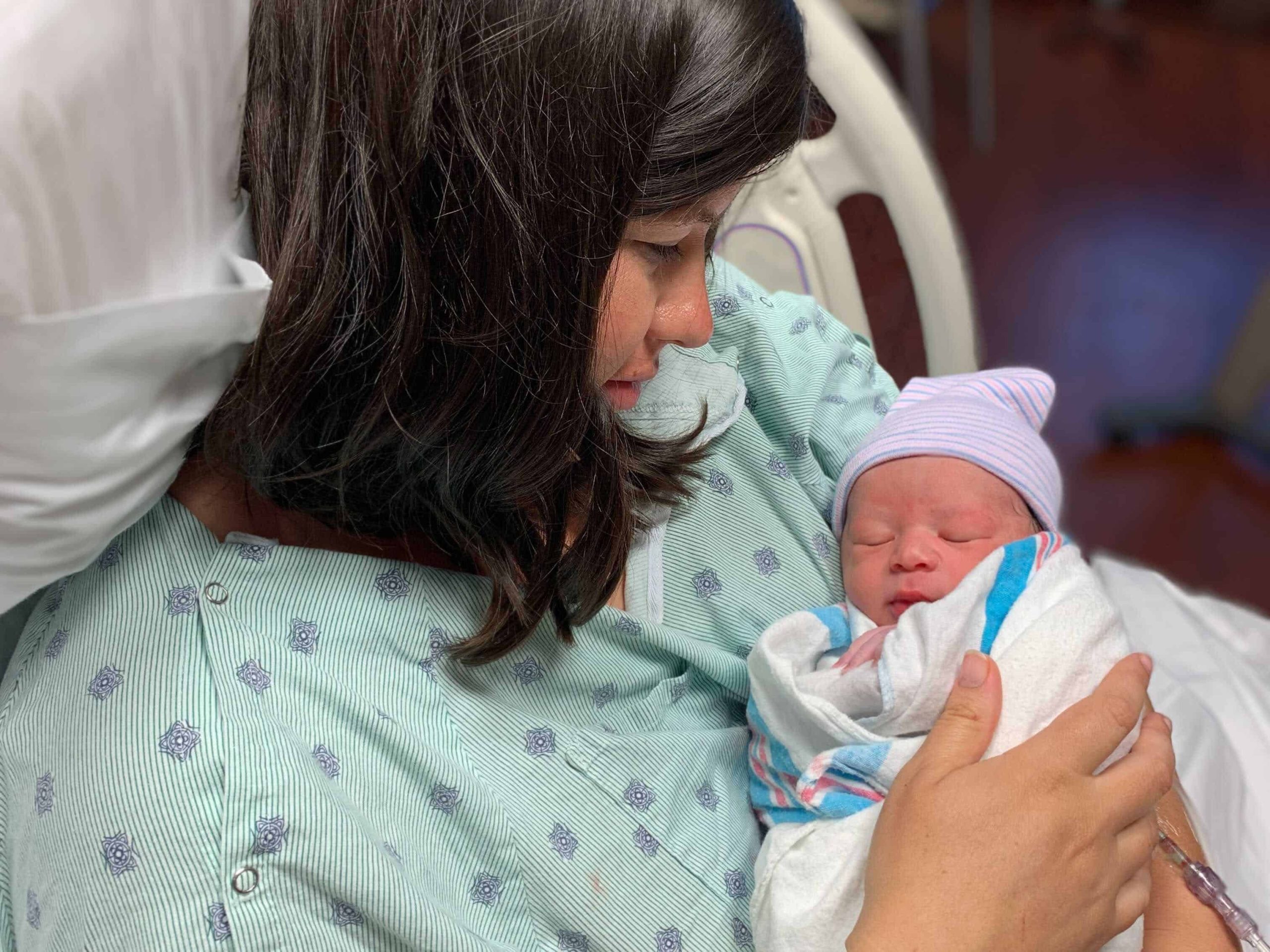 Liz Essley Whyte cradles her newborn while in the hospital. She chose to get the COVID-19 vaccine while pregnant.