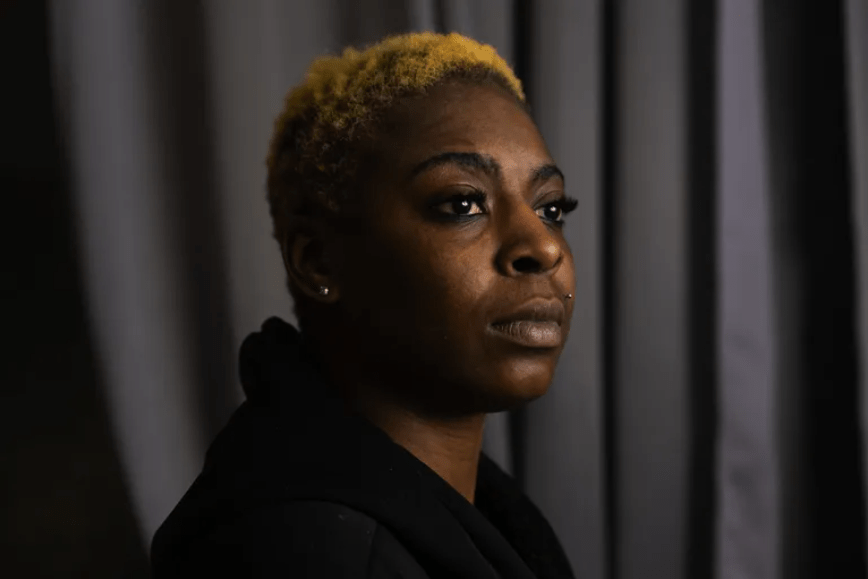 Shambrika Crawford looks off-camera with a serious expression