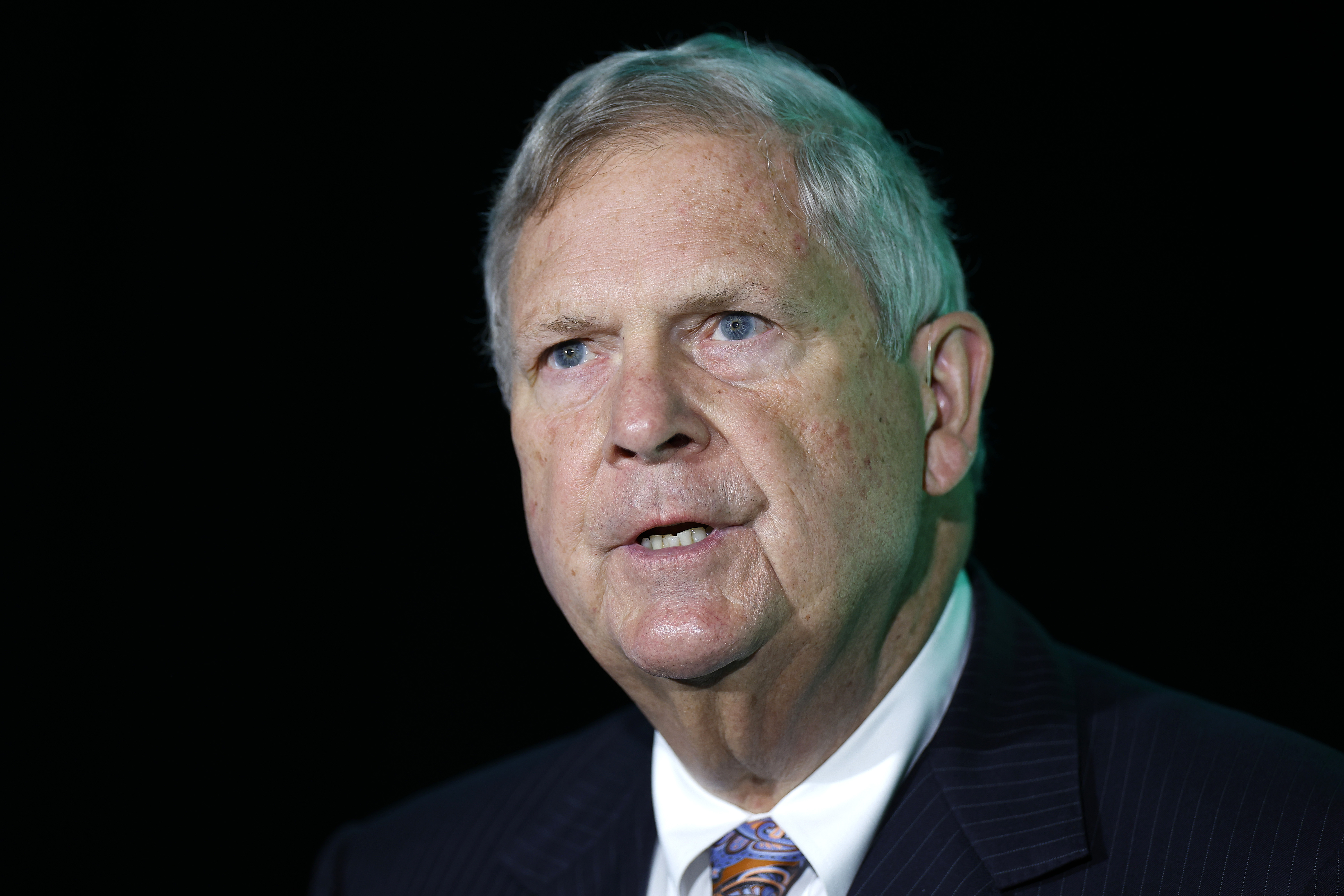A close-up of Tom Vilsack's face as he is speaking. 