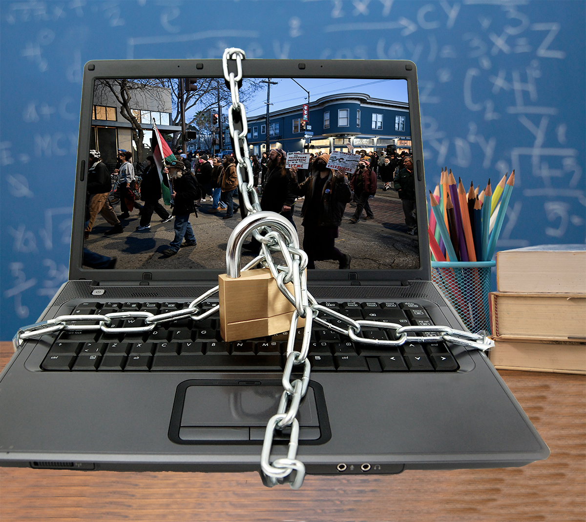 A laptop with a photo of a protest on its screen is shown with chains around it and a lock.