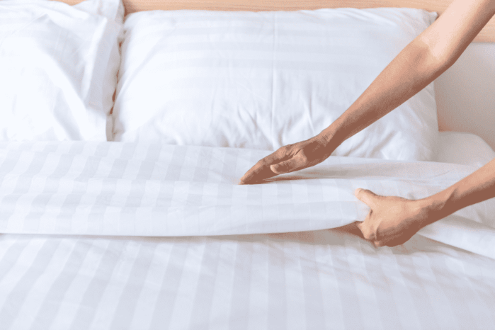 Hand set up white bed sheet in room Bedroom Decor Tips