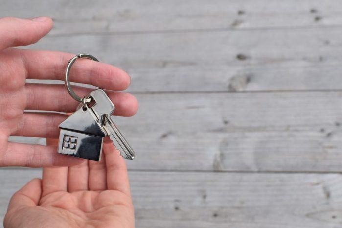 Hand taking house key Why People Sell Their Homes