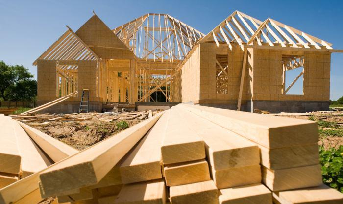 A new home being built with wood, trusses, supports and a foundation. Helical Piers