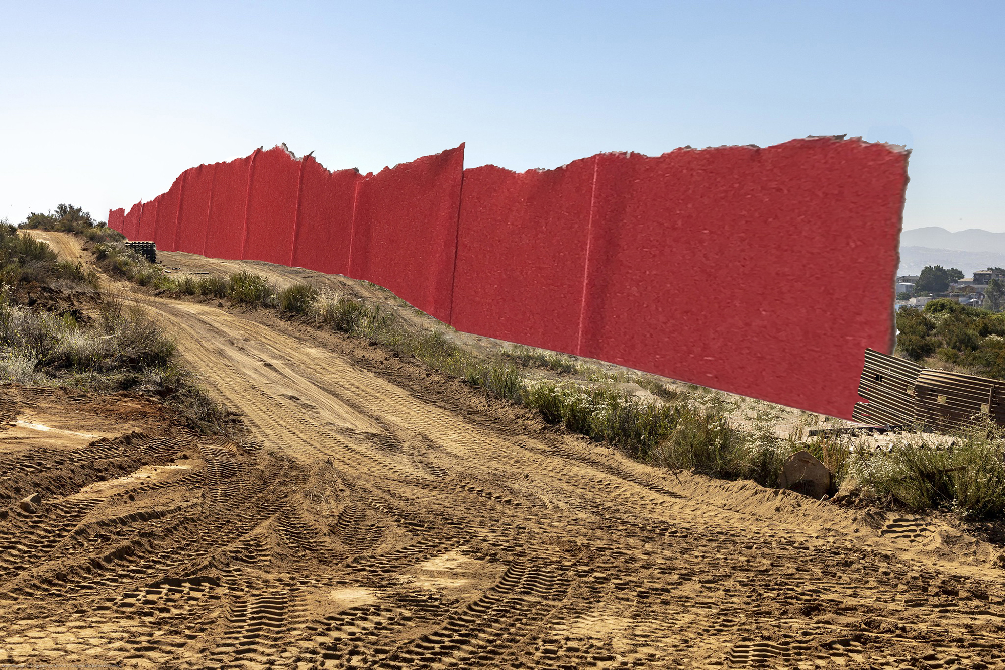 a border wall built out of red tape cuts through the desert