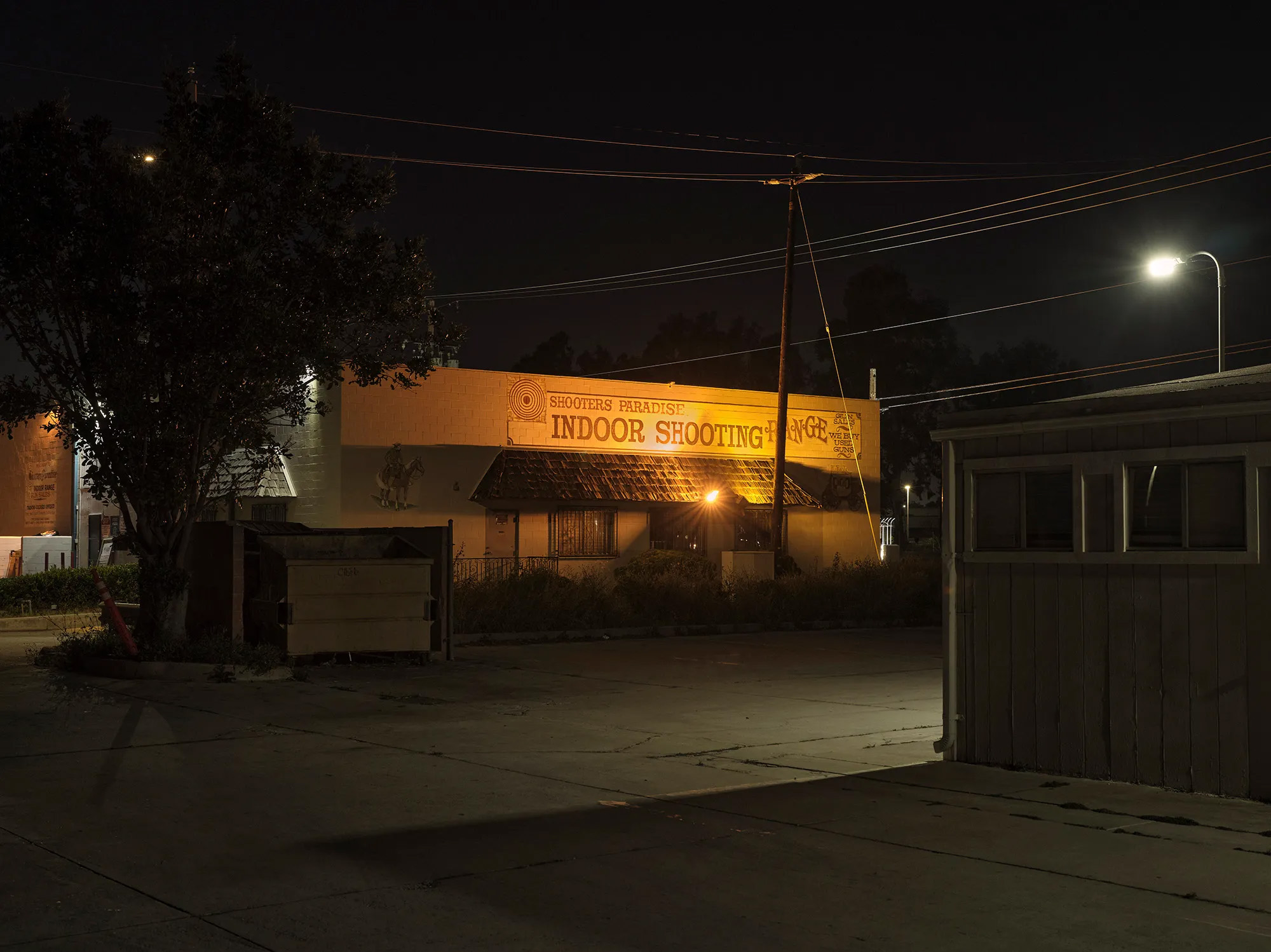 Exterior photo of Shooters Paradise at night.