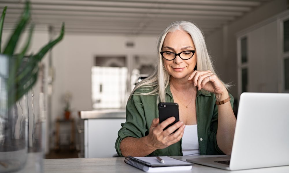 woman with smartphone and laptop