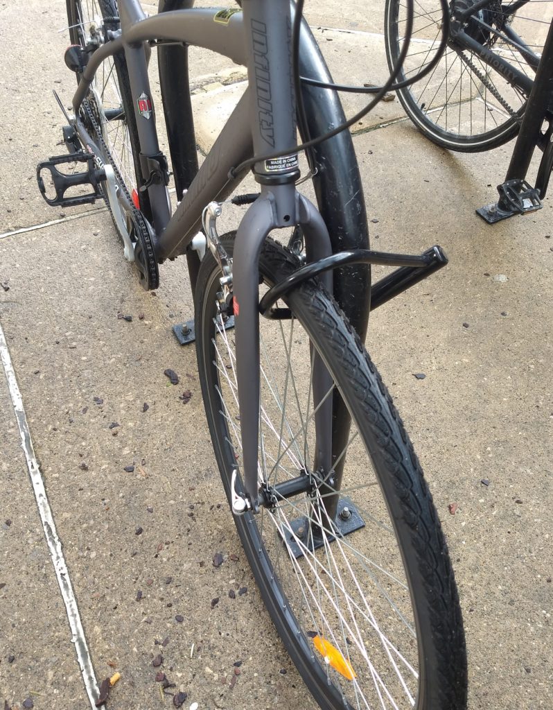 a bike locked up through the wheel