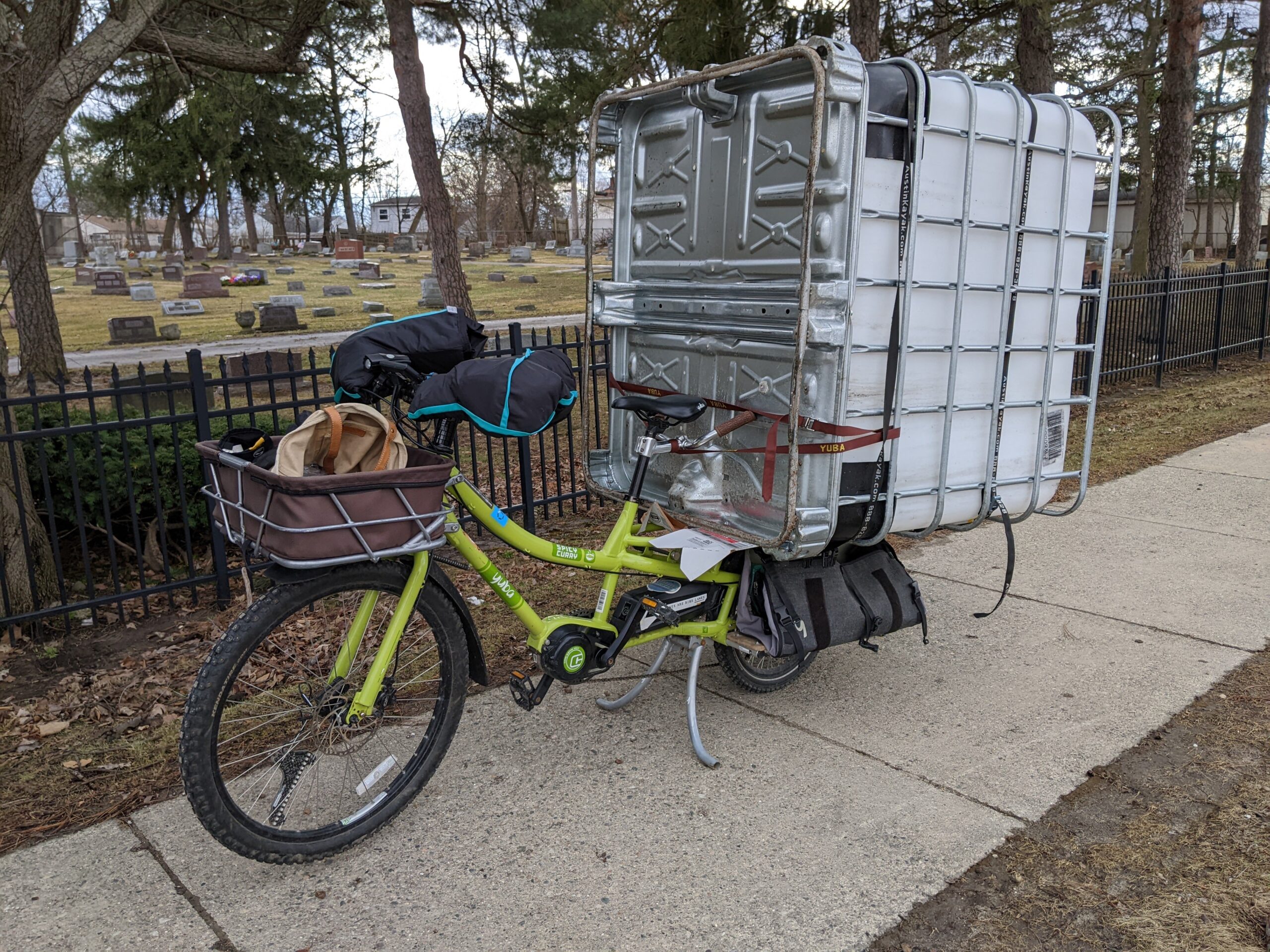 a longtail cargo bicycle carrying a 275 plastic tote in a metal cage