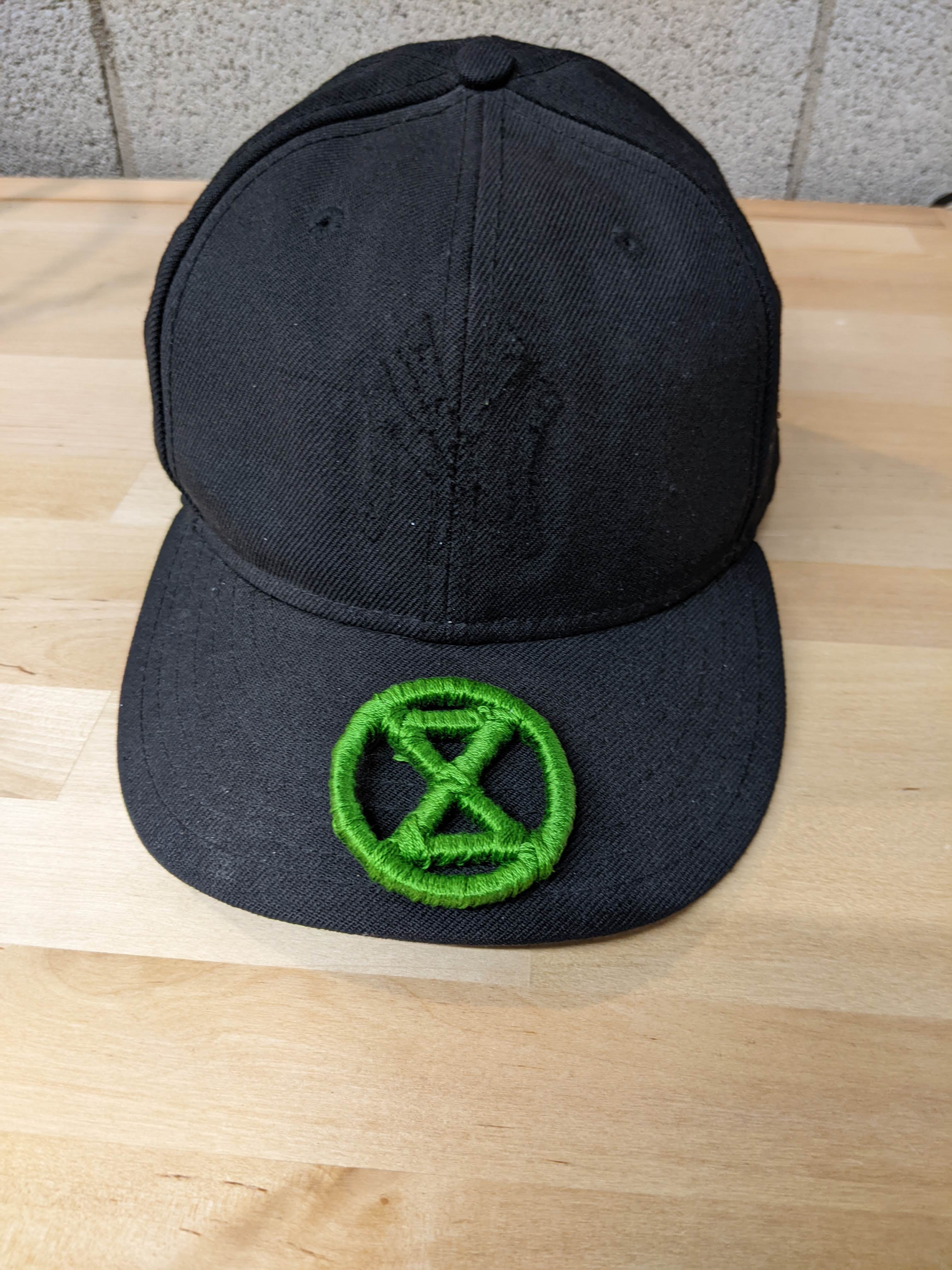 fully wrapped logo sitting on the brim of the hat