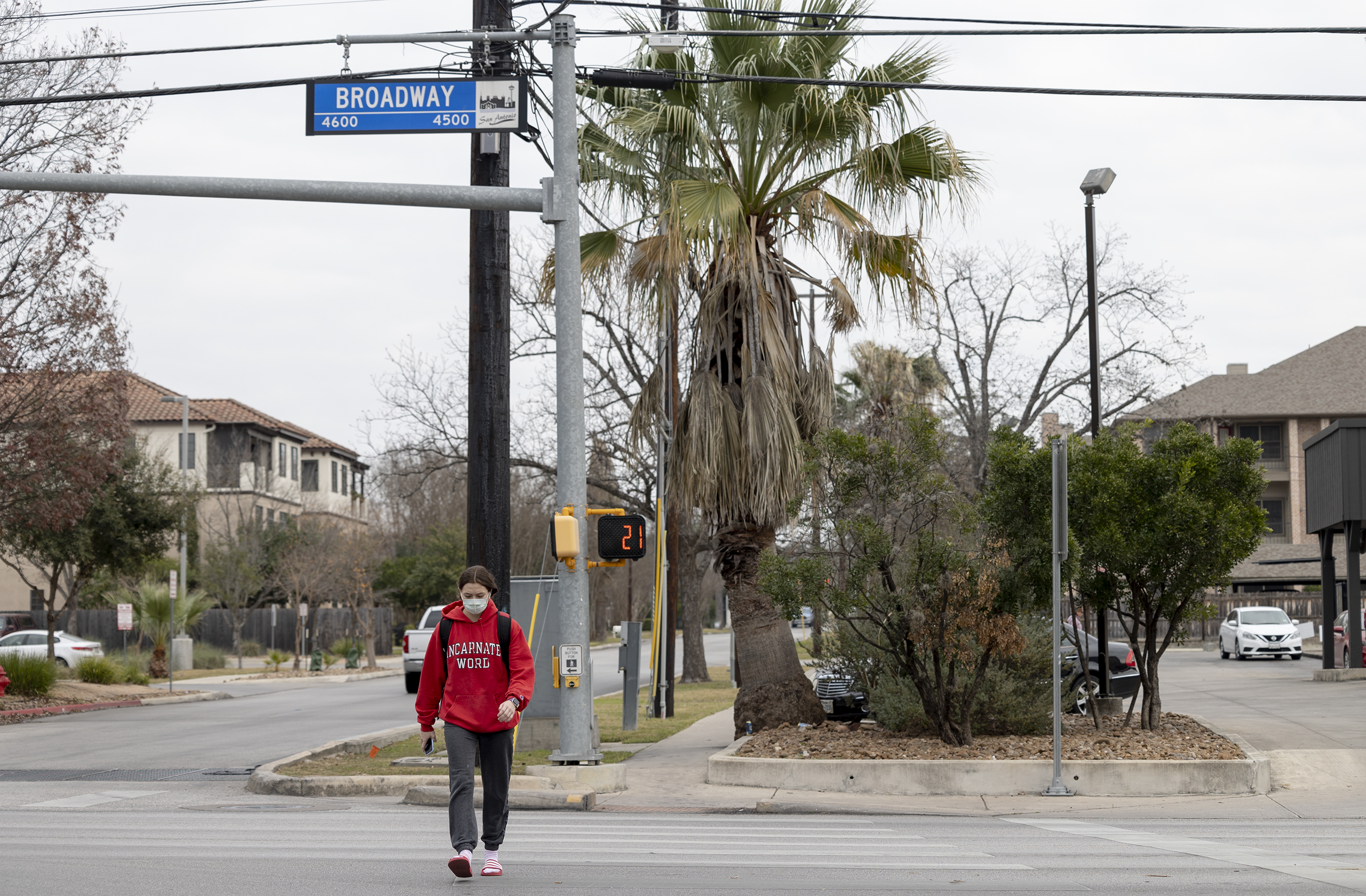 A woman walks across Broadway Thursday.