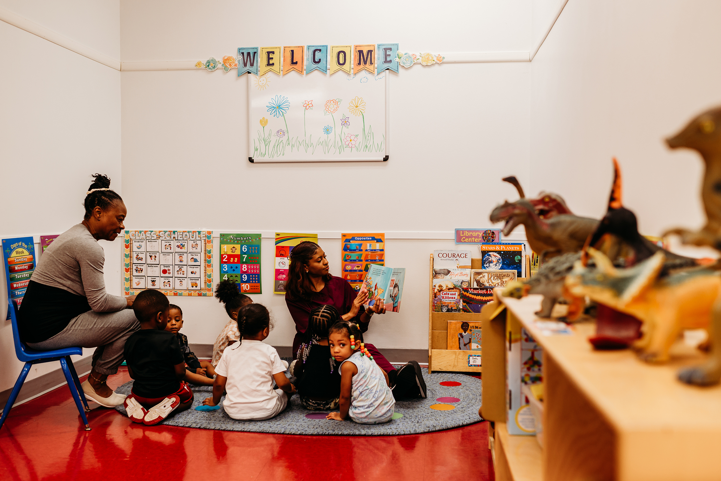 Raeann Campayne reads to students at Good Beginnings, a child care center in Maple Heights. Catherine Davis watches the students.