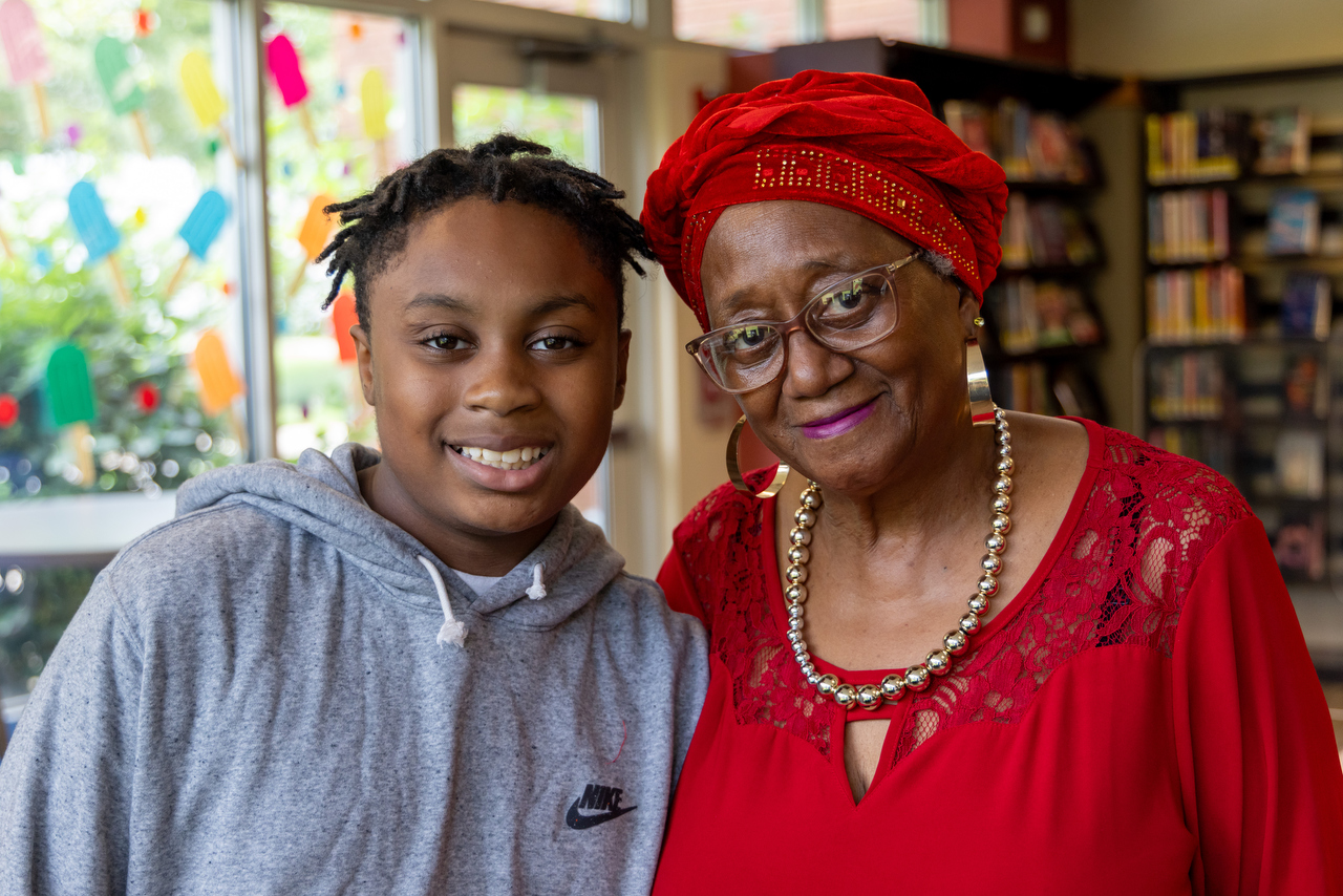 Shareefah Wahid (right) stands for a portrait with her grandson, Hasan Wahid, 11, Thursday, June 6, 2024, at Akron’s Maple Valley Branch Library. (Kassi Filkins / Signal Akron)