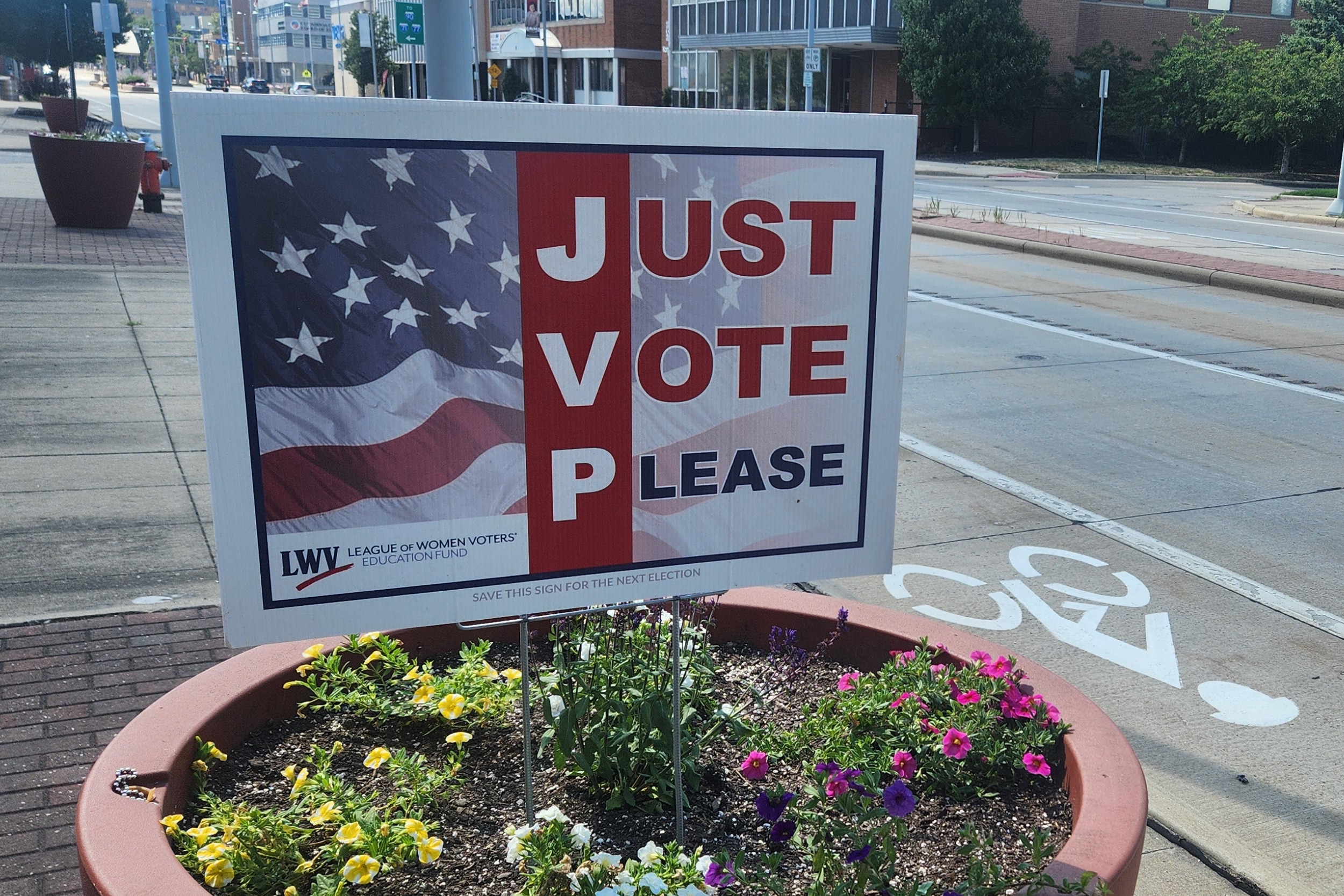 A sign that reads “Just vote please”