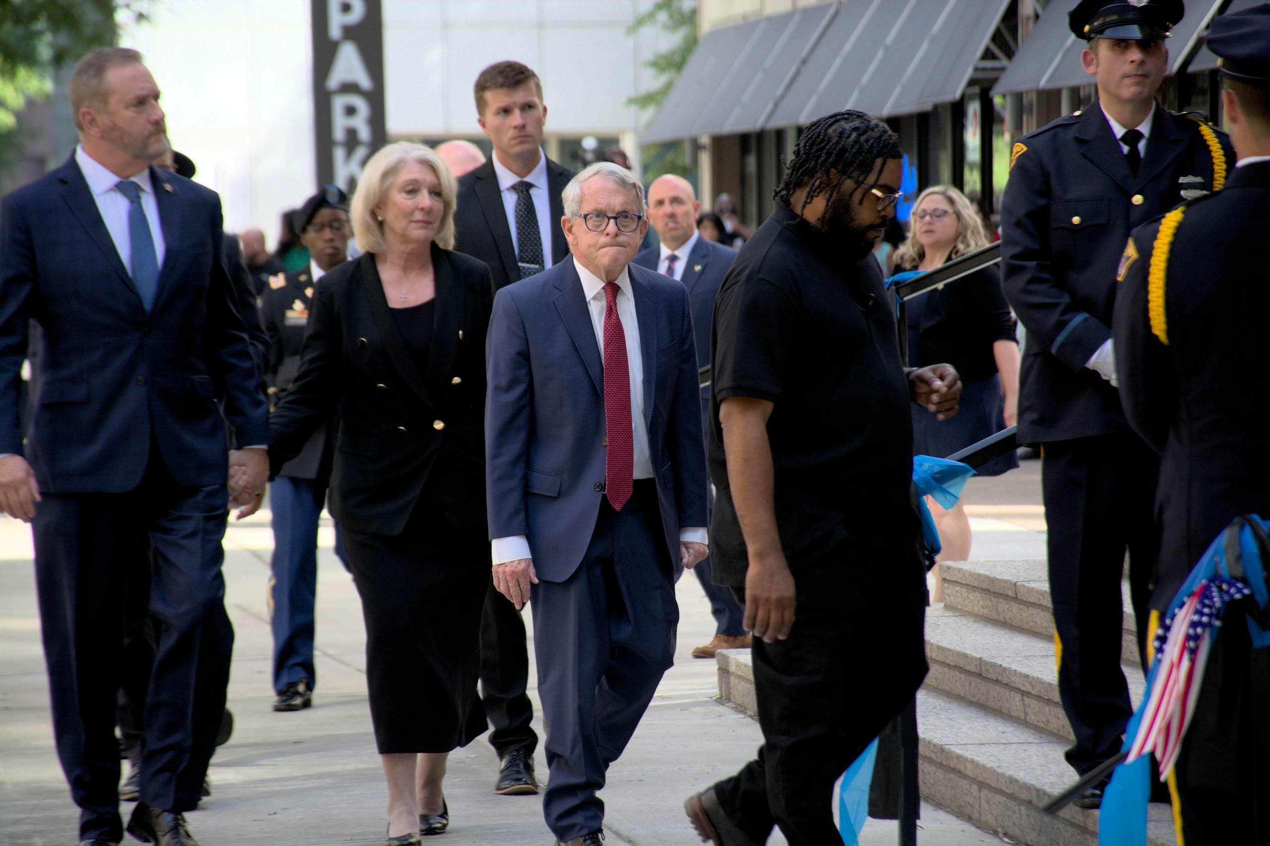 Ohio Gov. Mike Dewine, center, and Attorney General Dave Yost, left, arrive at the Cathedral of St. John the Evangelist for the memorial service for Cleveland Officer Jamieson Ritter.