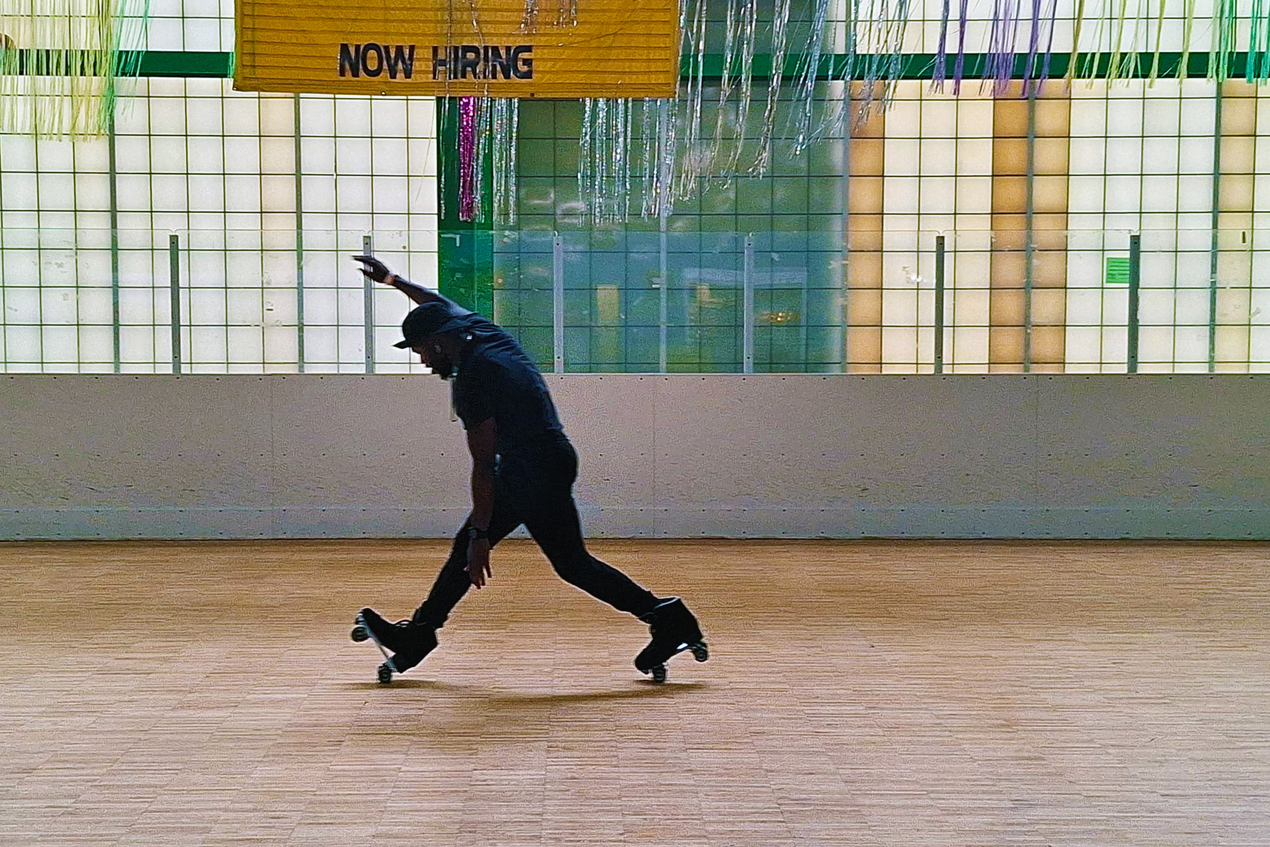 Rayshon Blake mastering the “heel-toe” skating trick at the Zelma Watson George roller skating rink.