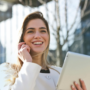 A young woman holding an ipad representing commercial business insurance