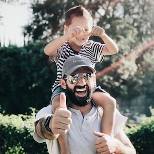 a dad holding his young son on his shoulders representing life insurance