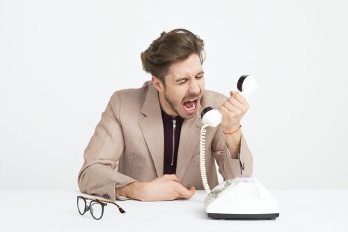 Angry man screaming into phone